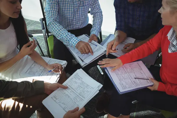 Business people sitting together with documents — Stock Photo, Image