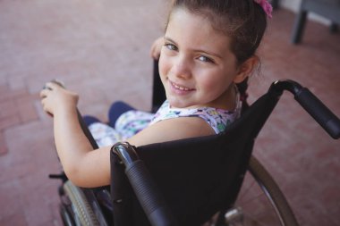 schoolgirl sitting on wheelchair clipart