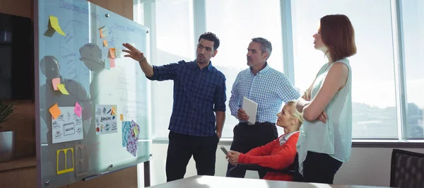 Businessman discussing with colleagues at office — Stock Photo, Image