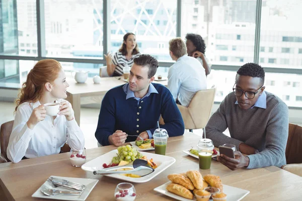 Business entrepreneurs sitting at breakfast table — Stock Photo, Image