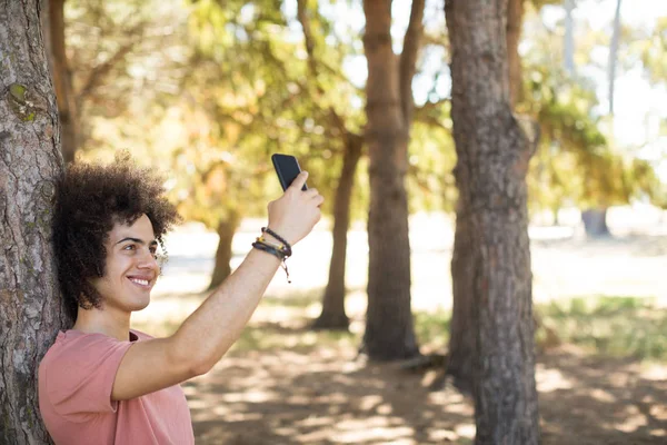 Smiling taking selfie at forest — Stock Photo, Image