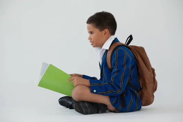 Schoolboy holding book — Stock Photo, Image