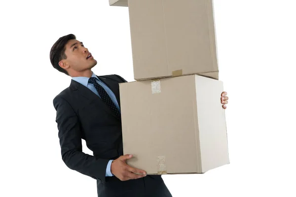 Businessman balancing cardboard boxes — Stock Photo, Image