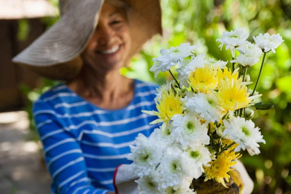 Senior vrouw bedrijf verse bloemen — Stockfoto