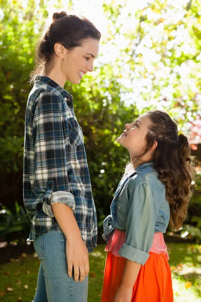 Madre e hija de pie en el patio trasero — Foto de Stock