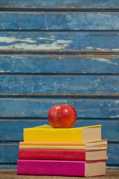 Libros apilados y manzana —  Fotos de Stock