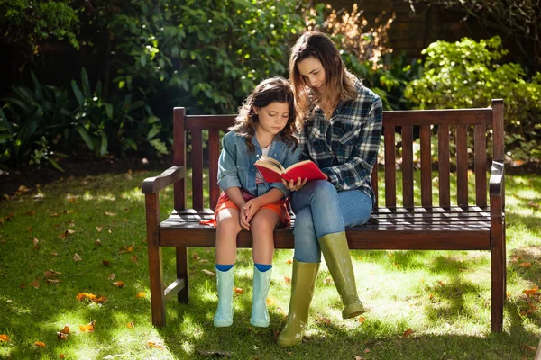 Vrouw leesboek met dochter — Stockfoto