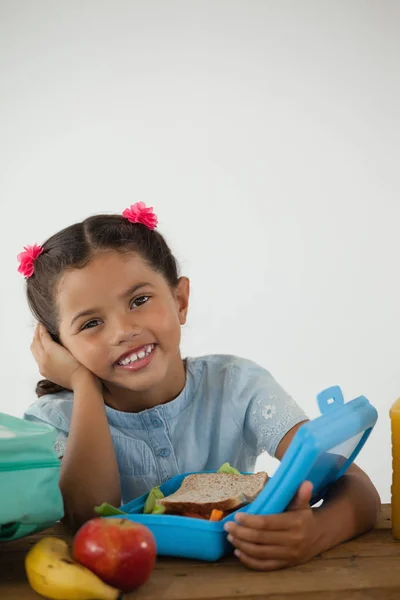 Schoolgirl sitting with tiffin box — Stock Photo, Image