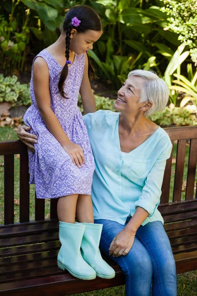 祖母和孙女坐在长椅上 — 图库照片
