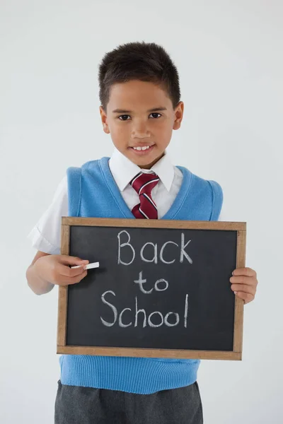 Schoolboy holding slate with text — Stock Photo, Image