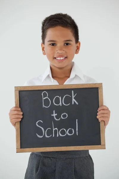 Schoolboy holding slate with text — Stock Photo, Image