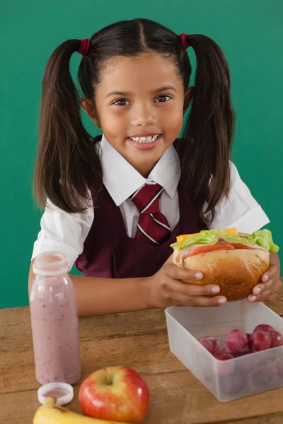 Schoolgirl having sandwich — Stock Photo, Image