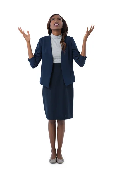 Businesswoman looking up and gesturing with hands — Stock Photo, Image