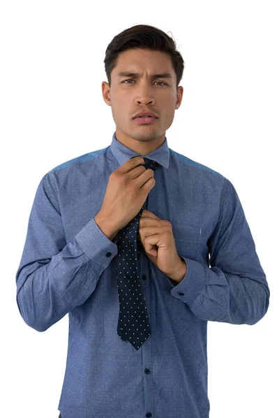 Young businessman adjusting necktie — Stock Photo, Image