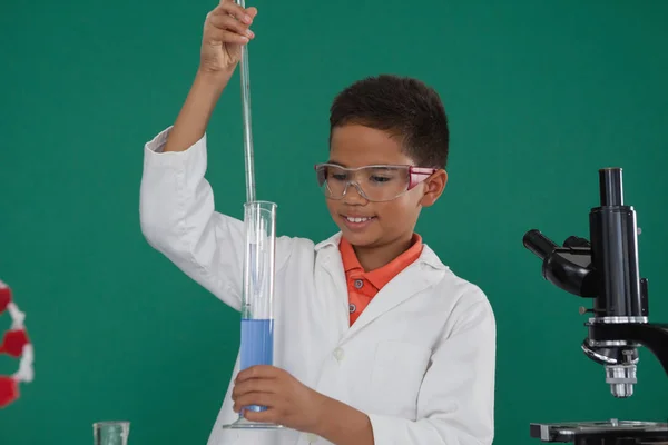 Schoolboy doing chemical experiment — Stock Photo, Image