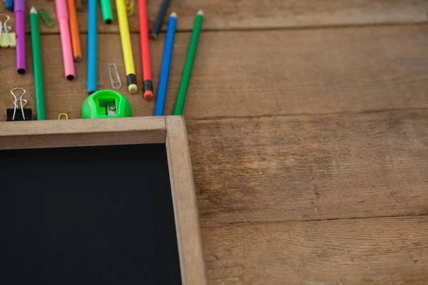 Colorful pencils and slate — Stock Photo, Image