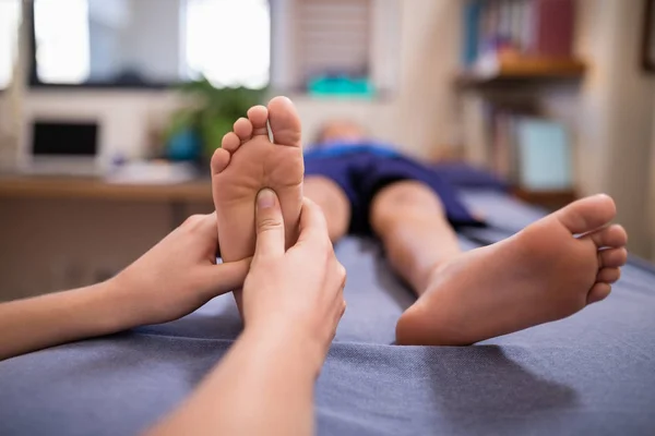 Terapeuta massageando sola do pé — Fotografia de Stock