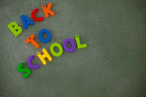 Block letters arranged on chalkboard — Stock Photo, Image