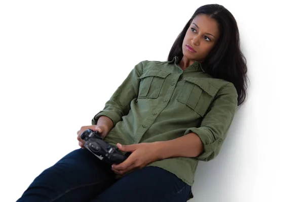 Thoughtful woman playing video games — Stock Photo, Image