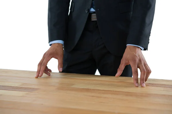 Businessman gesturing while standing at table — Stock Photo, Image