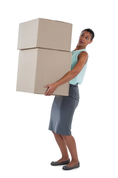 Businesswoman carrying heavy boxes — Stock Photo, Image