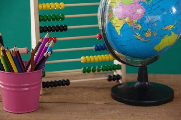 Globe with penholder and abacus — Stock Photo, Image