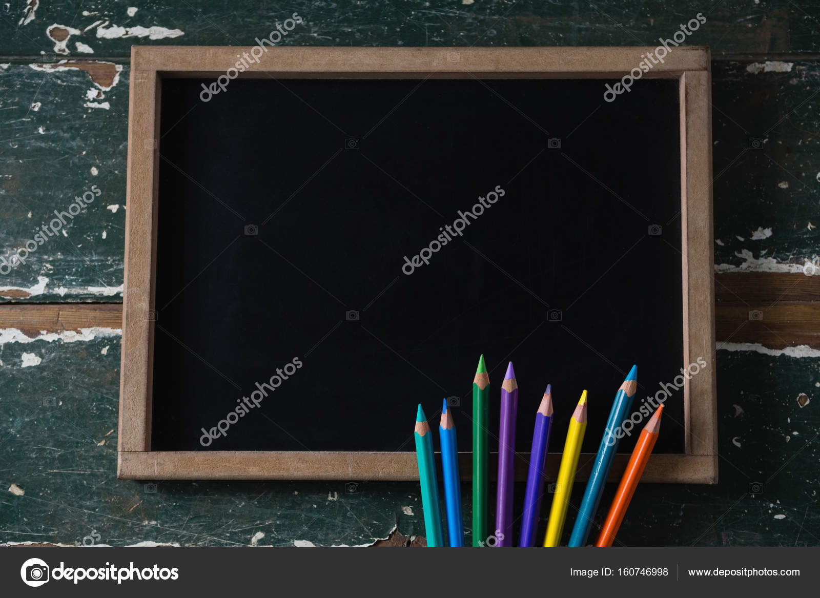 blank chalkboard and various colored pencil stock photo