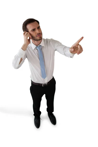 Confused businessman touching invisible interface — Stock Photo, Image