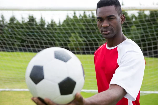 Male soccer player holding ball — Stock Photo, Image