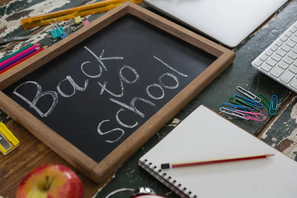 Text written on slate with school supplies — Stock Photo, Image