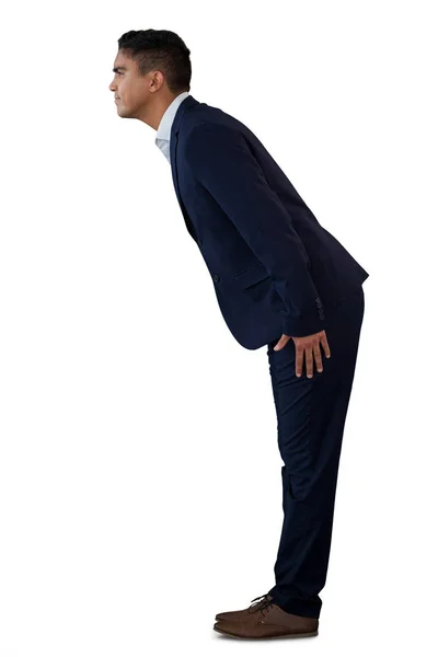Homem de negócios curvando-se em pé — Fotografia de Stock