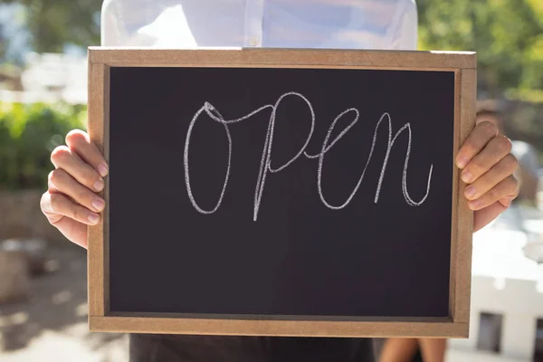Waitress standing with open sign board — Stock Photo, Image
