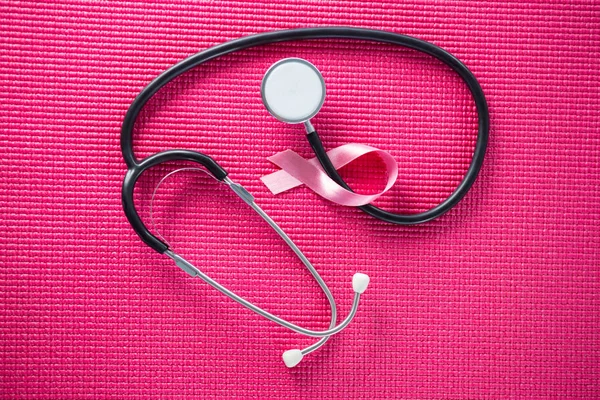 Stethoscope by pink Breast Cancer Awareness ribbon — Stock Photo, Image