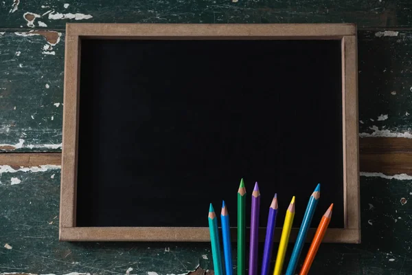 Blank chalkboard and various colored pencil — Stock Photo, Image