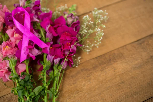 Pink Breast Cancer Awareness ribbon on flowers — Stock Photo, Image