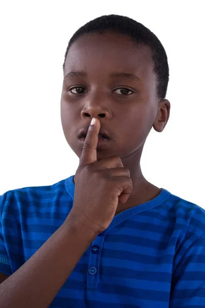 Portrait of boy with finger on lips — Stock Photo, Image