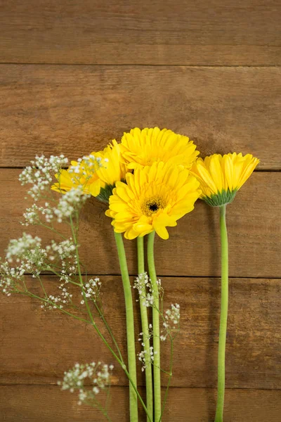 Fresh flowers on wooden table — Stock Photo, Image