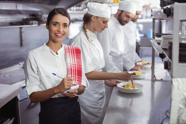 Waitress standing with notepad — Stock Photo, Image