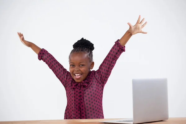 Cheerful woman with arms raised by laptop — Stock Photo, Image