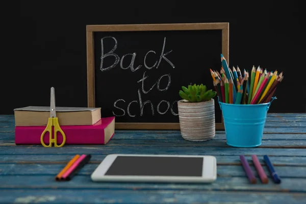 Text on slate with school supplies on tablet — Stock Photo, Image