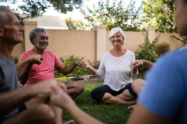 Senior people meditating with trainer — Stock Photo, Image