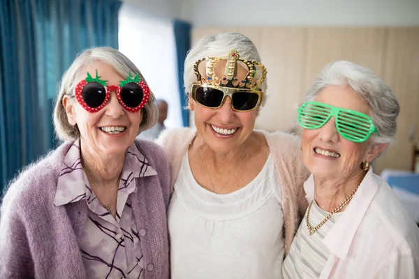 Senior women wearing novelty glasses — Stock Photo, Image