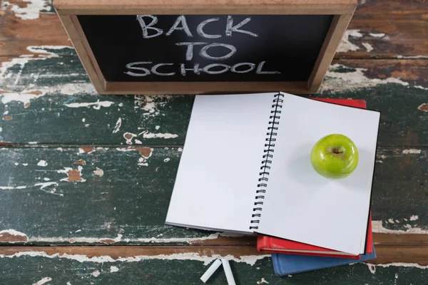 Books, apple and slate board — Stock Photo, Image