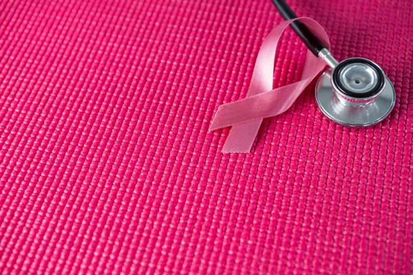 Stethoscope by pink Breast Cancer Awareness ribbon — Stock Photo, Image