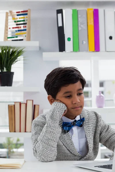 Bored businessman with hand on chin — Stock Photo, Image