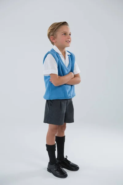 Schoolboy standing with arms crossed — Stock Photo, Image