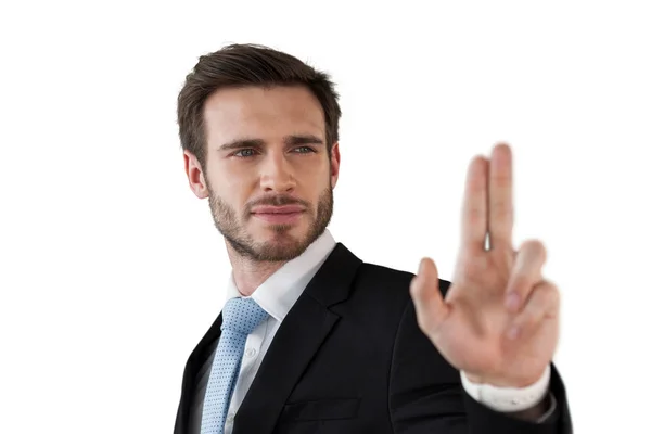 Confident businessman touching invisible interface — Stock Photo, Image