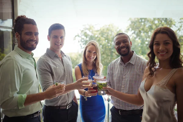 Gruppe von Freunden stößt mit Cocktailgläsern an — Stockfoto