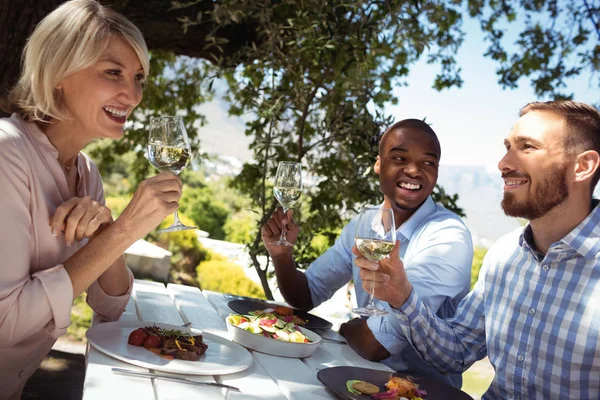 Friends having glass of champagne at restaurant — Stock Photo, Image