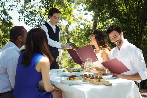 Vänner beställning till servitör — Stockfoto